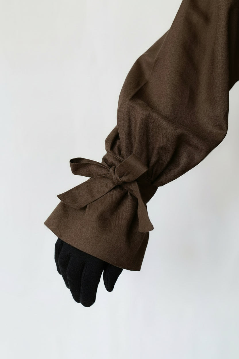 Brown sleeve with a tied cuff on a white background